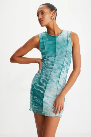Bodycon green water patterned dress sitting on the islands with female tulle mesh fabric lining