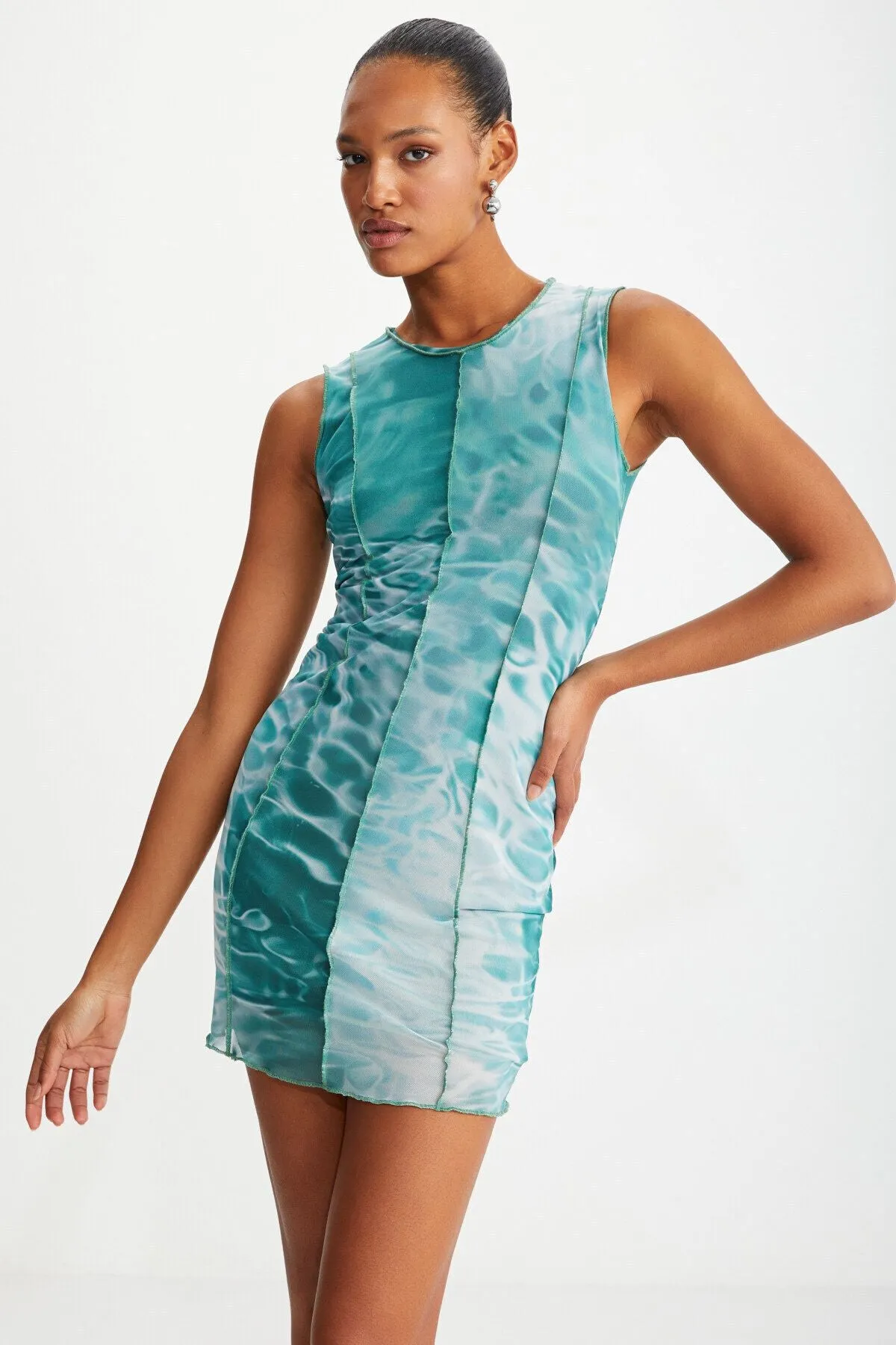 Bodycon green water patterned dress sitting on the islands with female tulle mesh fabric lining