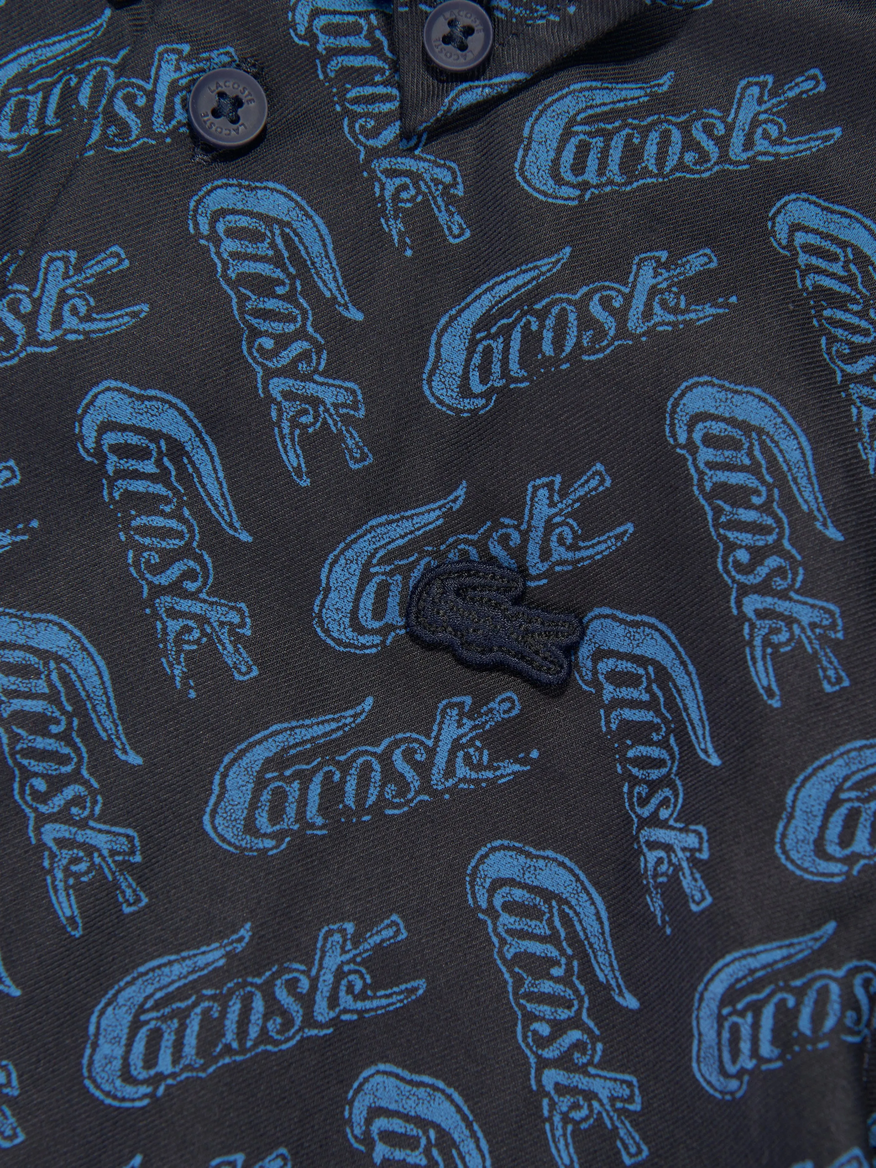 Lacoste Boys All Over Logo Shirt in Navy